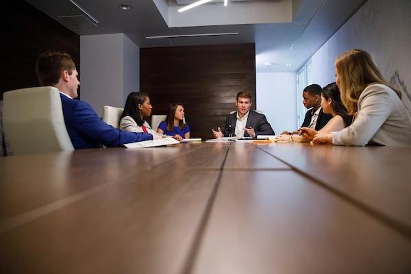 Students discuss a project in the Vulcan Value Partners Trading Room